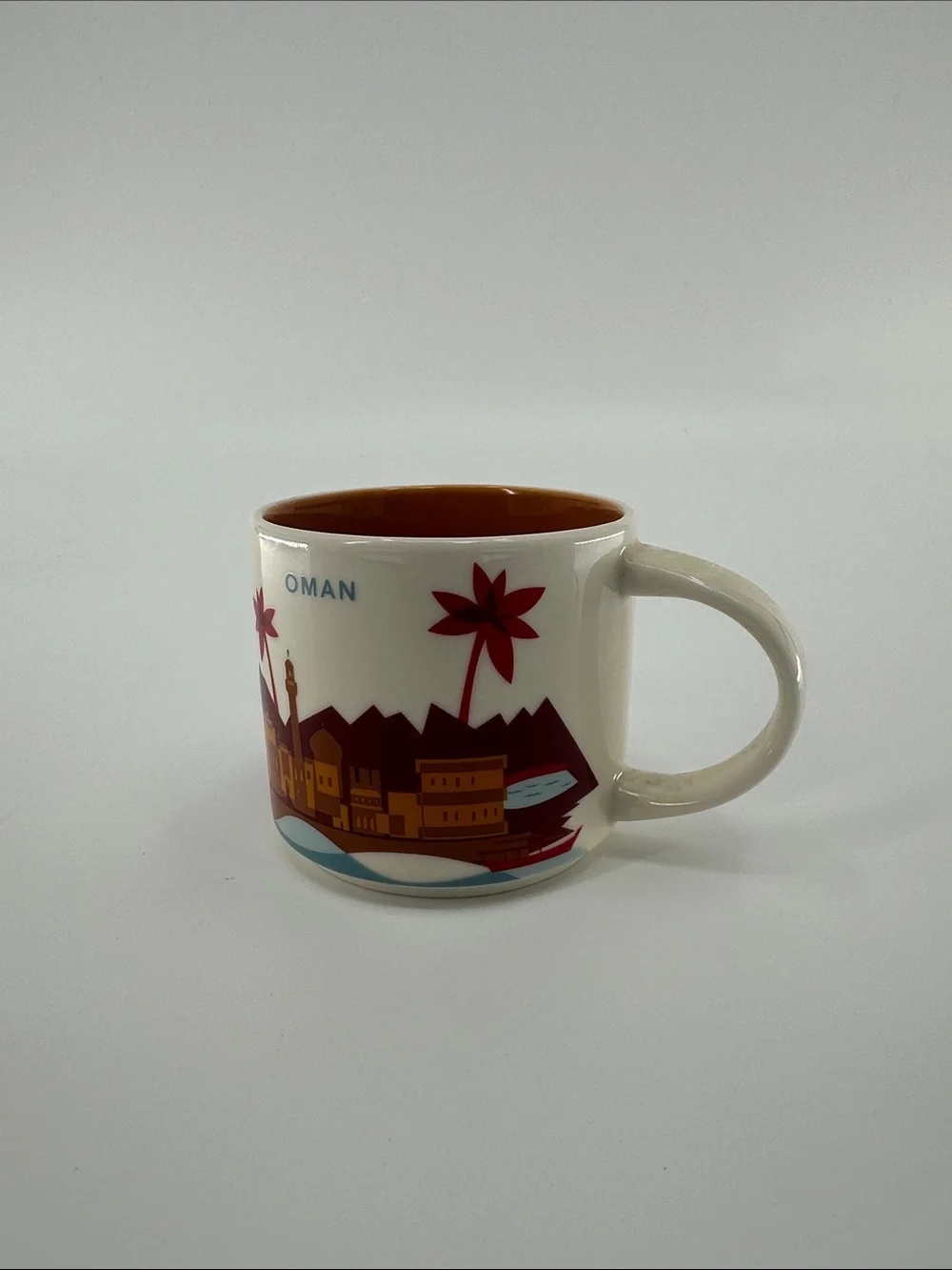 Starbucks Oman Cream Cityscape Mug with Orange Interior and Red Accents